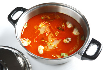 Hot pot of spicy tom yum in stew on white background