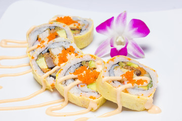 Shrimp tempura with fried egg in sliced bar with crab eggs, vege