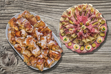 Plateful of Spit Roasted Pork Slices And Appetizer Savoury Dish Meze On Old Wooden Picnic Table