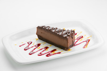 Chocolate cheese cake on white plate with sauce