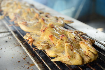 Roasting the whole chicken on the grill in asian restaurant