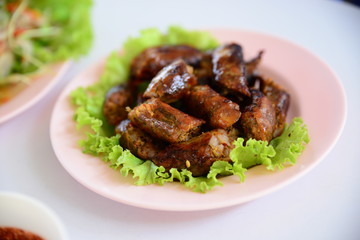 Chicken popper rolls with lettuce on white plate in restuarnt