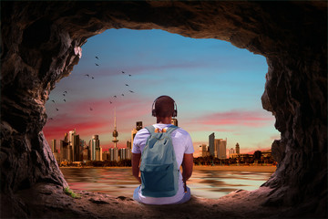 a man looking at the city view of kuwait from a cave - 121008384