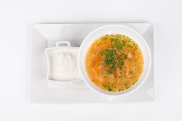 Russian cabbage soup with sauce on white bowl background