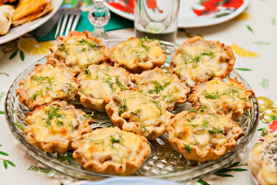 tartlets with cheese and mushrooms on a festive table