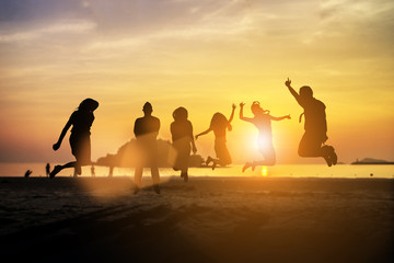 Silhouette friends jumping with joy and happiness over blurred,