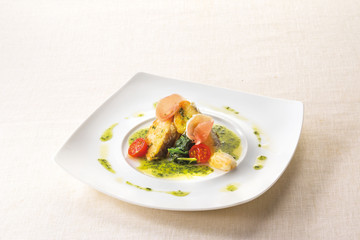 Poiret basil butter sauce of white fish on white plate backgroun
