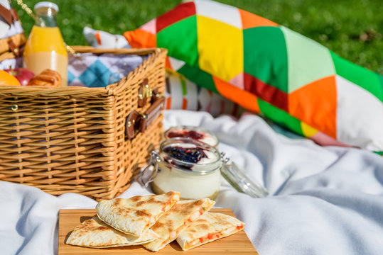 Picnic Basket With Fruits, Orange Juice, Croissants, Quesadilla And No Bake Blueberry And Strawberry Jam Cheesecake