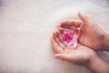 Hands holding Pink Ribbons , Breast cancer awareness, october pink, world cancer day