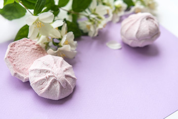 Pink round marshmallow in the background of jasmine. Beautiful sweets.