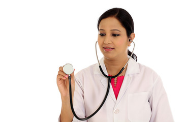 Female doctor with a stethoscope listening against white backgro