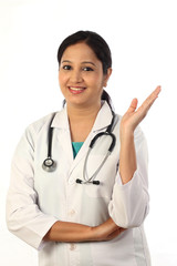 Young doctor woman presenting and showing copy space