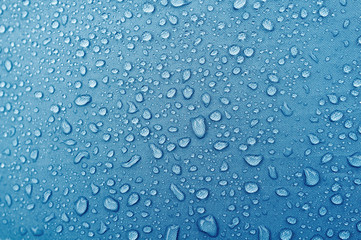 Water droplets on blue fiber waterproof fabric. - obrazy, fototapety, plakaty