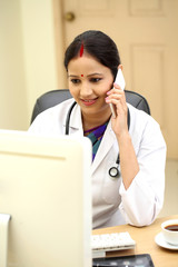 Traditional Indian female doctor talking on mobile phone