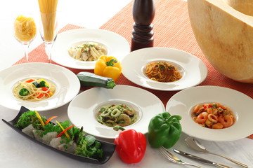 Soup, bread, salad, dessert with seafood and noodle pasta on whi