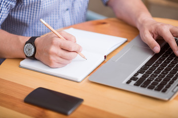 Fototapeta premium Nice man writing something down