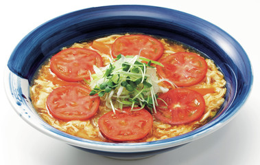 Delicious egg soup with sliced tomatoes and onion herbs in big c