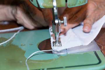Senior woman with a sewing machine