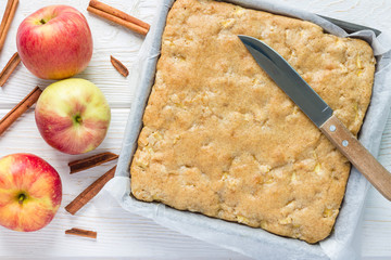 Homemade blondie brownies apple cake in baking dish, top view