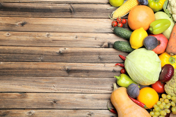 Obraz na płótnie Canvas Ripe fruits and vegetables on wooden table