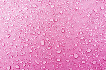 Water droplets on pink fiber waterproof fabric.