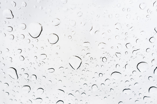 Drops of rain on glass, rain drops on clear window.