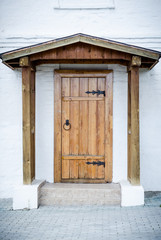 Fototapeta premium Wooden door with forged elements.