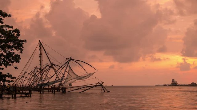 Chinese fishnets in Cochin, Kerala, India at sunset. Time-lapse of the coast