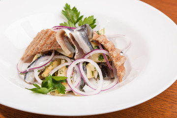 Salad with potatoes sprat and onions