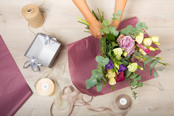 Flowers and floristic equipment arranged on a wooden background