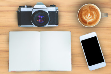 Coffee,notebook,mobilephone and camera on teak wood texture back