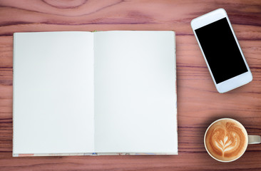 Coffee,notebook and mobile phone on teak wood texture background