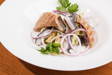 Salad with potatoes sprat and onions