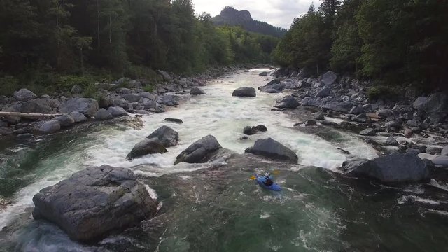 Drone Follows Extreme Kayaker Down Raging River in Mountain Forest