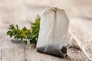 Abwaschbare Fototapete tea bag and fresh thyme © natashamam35