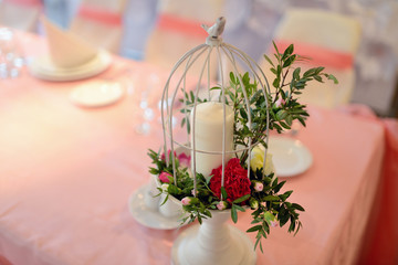 Beautiful wedding restaurant for marriage. White decor for bride and groom. Colorful decoration for celebration. Beauty bridal interior. Bouquet, food and flowers in hall