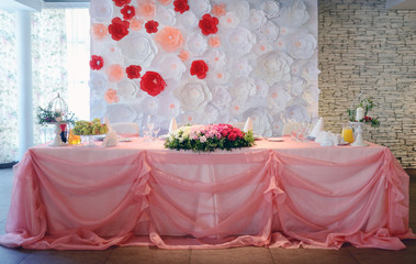 Beautiful wedding restaurant for marriage. White decor for bride and groom. Colorful decoration for celebration. Beauty bridal interior. Bouquet, food and flowers in hall