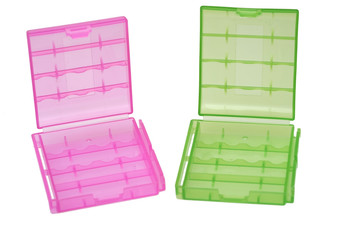 Two plastic battery holder and one battery on white
