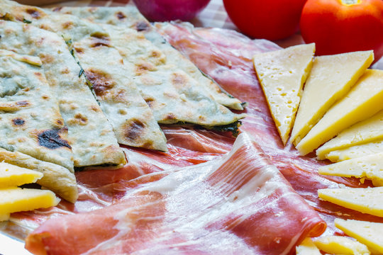 Soparnik with prosciutto and cheese.