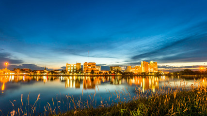 city at night with reflection of skyline in the lake