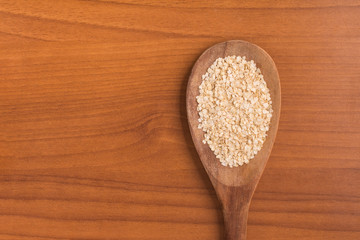 Quinoa Flakes into a spoon.