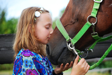 YOUNG GIRL HUGGING AND KISSING TRAKEHNER PINTO HORSE
