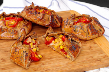 Spicy rye galettes with tomatoes, corn and ricotta