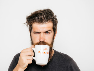 bearded serious man with cup of coffee or tea