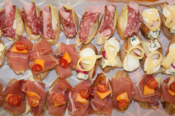Fototapeta na wymiar Selection of Spanish tapas served on a sliced baguette.