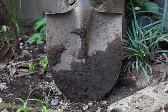 A shovel covered with mud