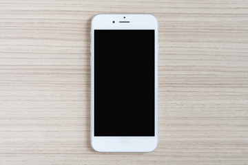 Cellphone on wood background.