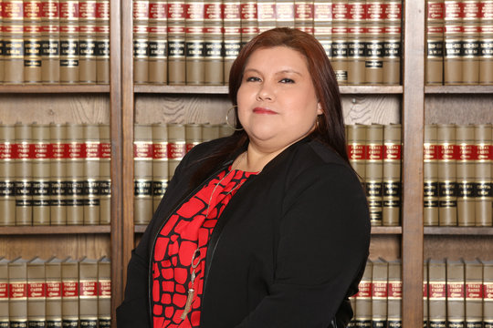 Hispanic woman lawyer in law library