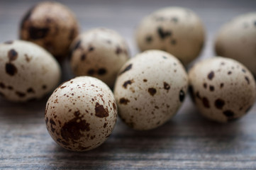 Quail eggs on a gray wooden board
