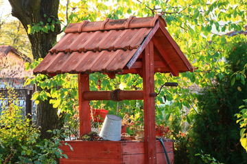 Wooden water well in the garden
